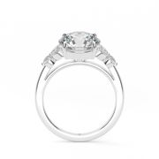 White Gold Round Shape Diamond Side Stone Engagement Ring With Shared Prong Setting.